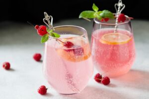 rose lemonade in glasses with raspberry garnish