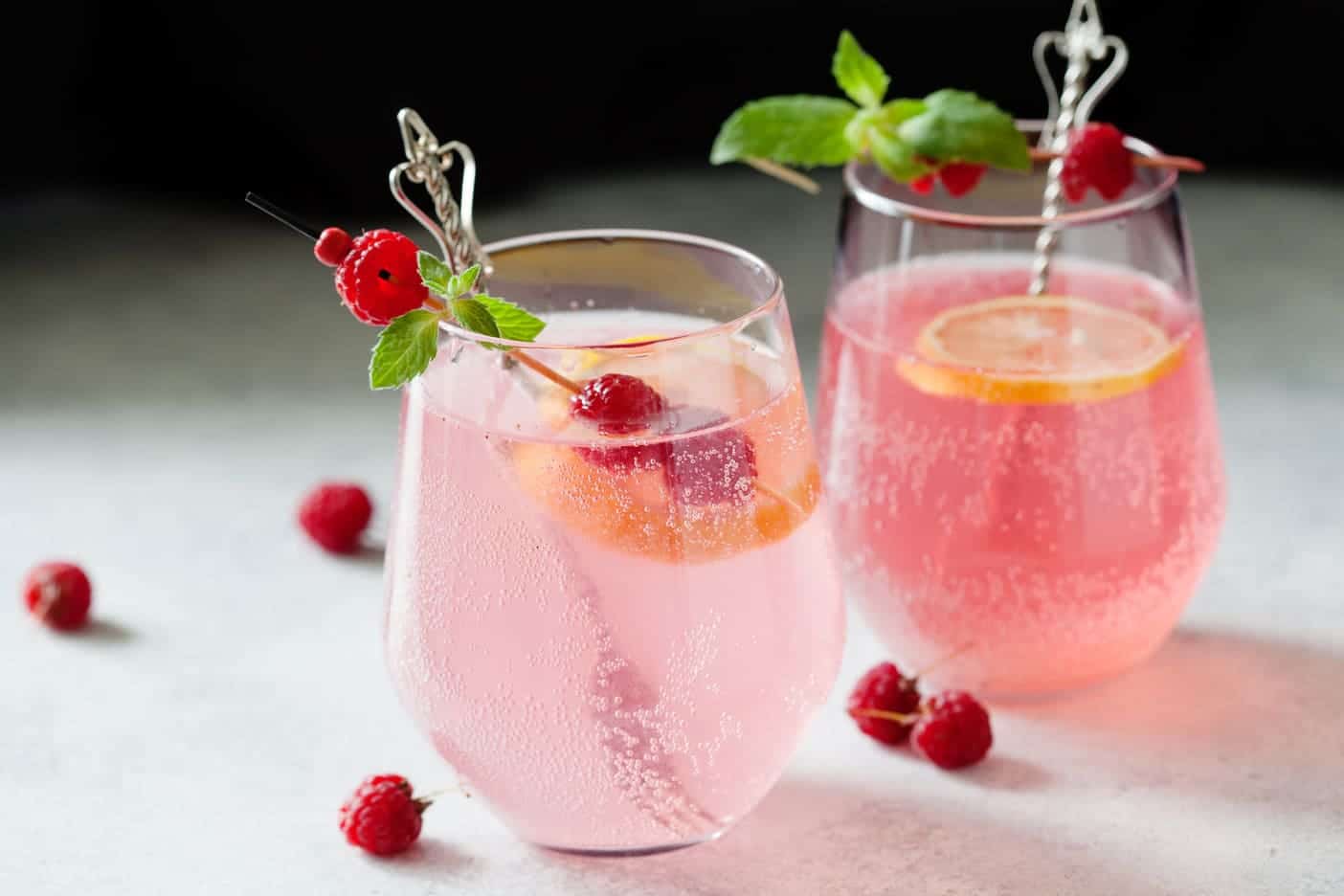 rose lemonade in glasses with raspberry garnish