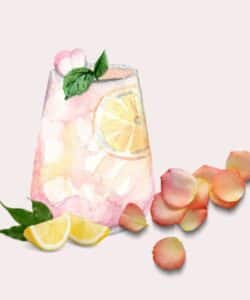 wine glass with rose lemonade and lemons and rose petals