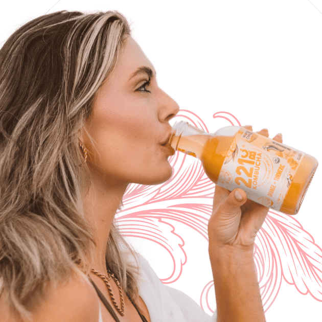 lady drinking orange + tangerine kombucha flavor